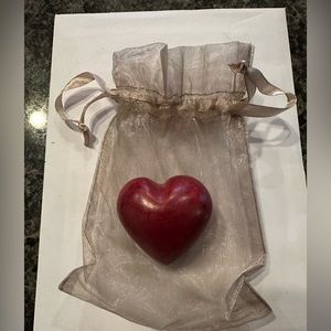 Weighty red heart shaped object with its own mesh bag.  I have six (6) of these.